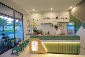 a man standing at a counter in a restaurant at The Sol House in Phú Quốc