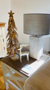 a table with a lamp and a christmas tree on it at Harbour Retreat Padstow - Entire Apartment in the beautiful old town of Padstow Harbour in Padstow