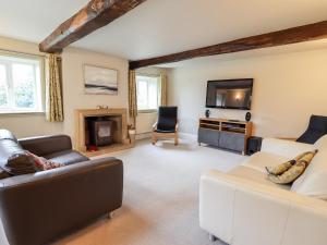 a living room with two couches and a tv at South Hillswood Farm in Leek