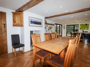 a dining room with a wooden table and chairs at South Hillswood Farm in Leek
