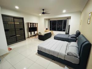 a bedroom with a bed and a couch and a living room at Damen Suite Sunway Subang by DW in Subang Jaya