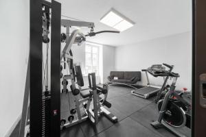 a room with a gym with several tread machines at #FER RÊVER 63# Jacuzzi #Salle de Sport en supplément et sur demande#Musculation in Thiers