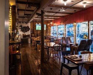 a restaurant with tables and chairs in a room at Akureyri Backpackers in Akureyri