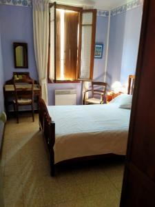 1 dormitorio con 1 cama, mesa y sillas en paradis des randonneurs, en Roquefort-des-Corbières