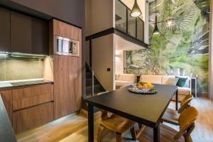 a kitchen and dining room with a table and chairs at Design Club Collection in Bologna