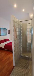 a bedroom with a walk in shower and a bed at Casa Flora in Taranto