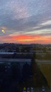 a sunset over a city with cars in a parking lot at Henriett’s cosy places in Satu Mare +5 photos