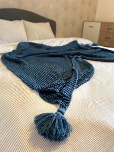 a blue blanket on top of a bed at Henriett’s cosy places in Satu Mare +5 photos