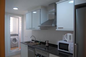 cocina con fregadero y microondas en Coll Verd Apartment, en Denia
