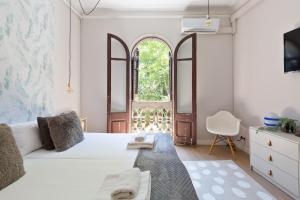 a bedroom with a white bed and a window at Sagrada Familia IV by Enjoy Apartments in Barcelona