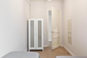 a white room with a bed and a closet at Sagrada Familia IV by Enjoy Apartments in Barcelona