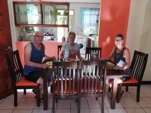 a group of three people sitting at a table at Danglez Bed & Breakfast in Bataka