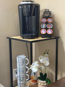 a shelf with a coffee maker and cups on it at Ocean View Renovated Condo With Pool - DAYTONA BEACH in Daytona Beach