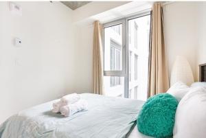 a bedroom with a bed with a stuffed animal on it at The Catherinoise, Condo in heart of downtown in Montreal