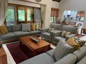 a living room with couches and a coffee table at Kruger Park Lodge, Kubu Lodge 224 in Hazyview