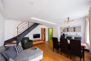 a living room with a couch and a table with chairs at Nobles Apartments in Prague
