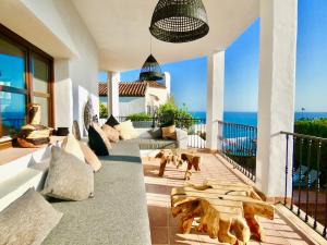 a living room with a couch and dogs on a balcony at Casa Alba in Nerja