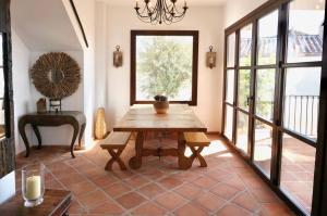 a dining room with a table and a window at Casa Alba in Nerja