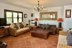 a living room with couches and a television at Casa Alba in Nerja