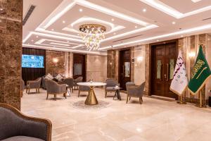 a lobby with chairs and a table and a chandelier at idles By Staytion Serviced Apartments in Jeddah