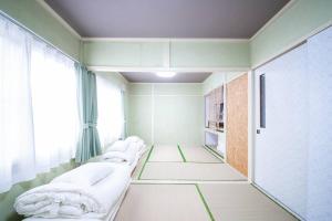Vuode tai vuoteita majoituspaikassa Otaru Shikkui Cottage