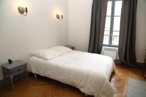 Ένα ή περισσότερα κρεβάτια σε δωμάτιο στο Appartement Bourgeois