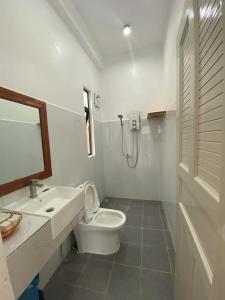 a white bathroom with a toilet and a sink at Kampot River Bungalow by MAMA in Kampot