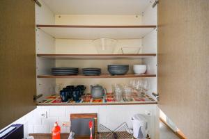 a cupboard with plates and dishes on it at Central Apartment for City Explorers 224 in Zurich