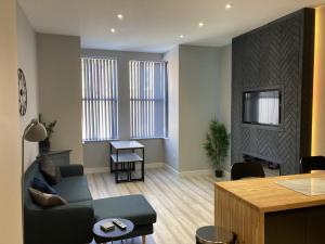 a living room with a couch and a table at Vibe Holiday Apartments in Blackpool