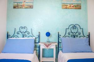A bed or beds in a room at Villino Agave