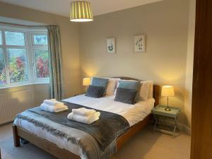 a bedroom with a bed with two towels on it at No 12 - Stylish & homely 3 bed with parking close to city centre in Bath