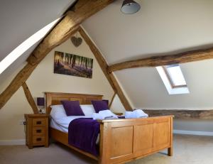a bedroom with a bed in a attic at The Hayloft in Knighton