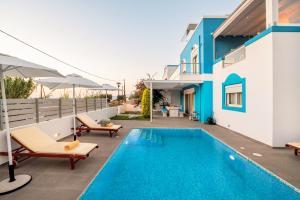 a villa with a swimming pool and a house at Seabreeze Villa - with Jacuzzi & heated pool in Mastihari