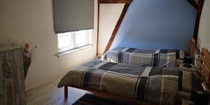 a bedroom with two beds and a window at S&H Ferienwohnung in Usedom Town