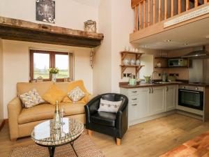 a living room with a couch and a table at Tegfan Barn in Pant-y-dwr +8 photos