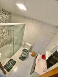 een badkamer met een glazen douche en een toilet bij A casa miracles in São Miguel dos Milagres