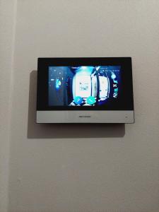 a television on a wall with a camera on it at Апартаменты в ЖК Only Sun in Prigorodnyy