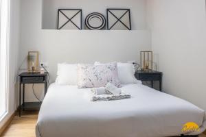 1 dormitorio con 1 cama blanca y 2 mesitas de noche en Writer's Home by Cadiz Time, en Cádiz