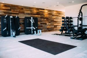 a gym with a wall of gym equipment at Lakeside property with spa access on a nature reserve Maple House BV08 in Warmwell