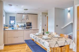 a kitchen and dining room with a table and chairs at Luxury property with access into Spa on a nature reserve Beaumont Village 5 BV05 in Warmwell