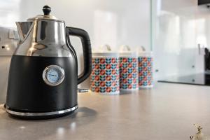 a black and silver tea kettle sitting on a counter at Smythen St, 2 bed apartment with balcony in Exeter