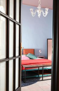 een slaapkamer met een bed en een kroonluchter bij The colors house in Bari