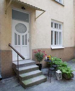 eine Eingangstür eines Hauses mit einem Tisch und einer Treppe in der Unterkunft Apartament Żurawia street in Warschau