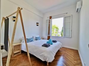 a bedroom with a bed and a window at LE FOCH by Booking Guys in Villefranche-sur-Mer