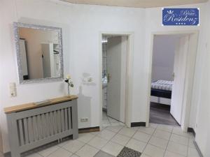 a bathroom with a vanity and a mirror and a sink at Saphir Suite in Westerdeichstrich