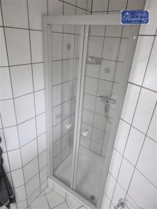 a shower with a glass door in a bathroom at Saphir Suite in Westerdeichstrich