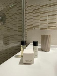 a bathroom with two products sitting on a counter at Guarracino P. Capodimonte Suite in Naples