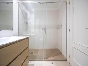 a shower with a glass door in a bathroom at Paraguay 14 in Vigo