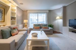 a living room with two couches and a tv at Paraguay 14 in Vigo