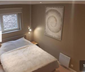 a bedroom with a bed and a window at Terrasses de Malmedy Lodge 417 in Malmedy